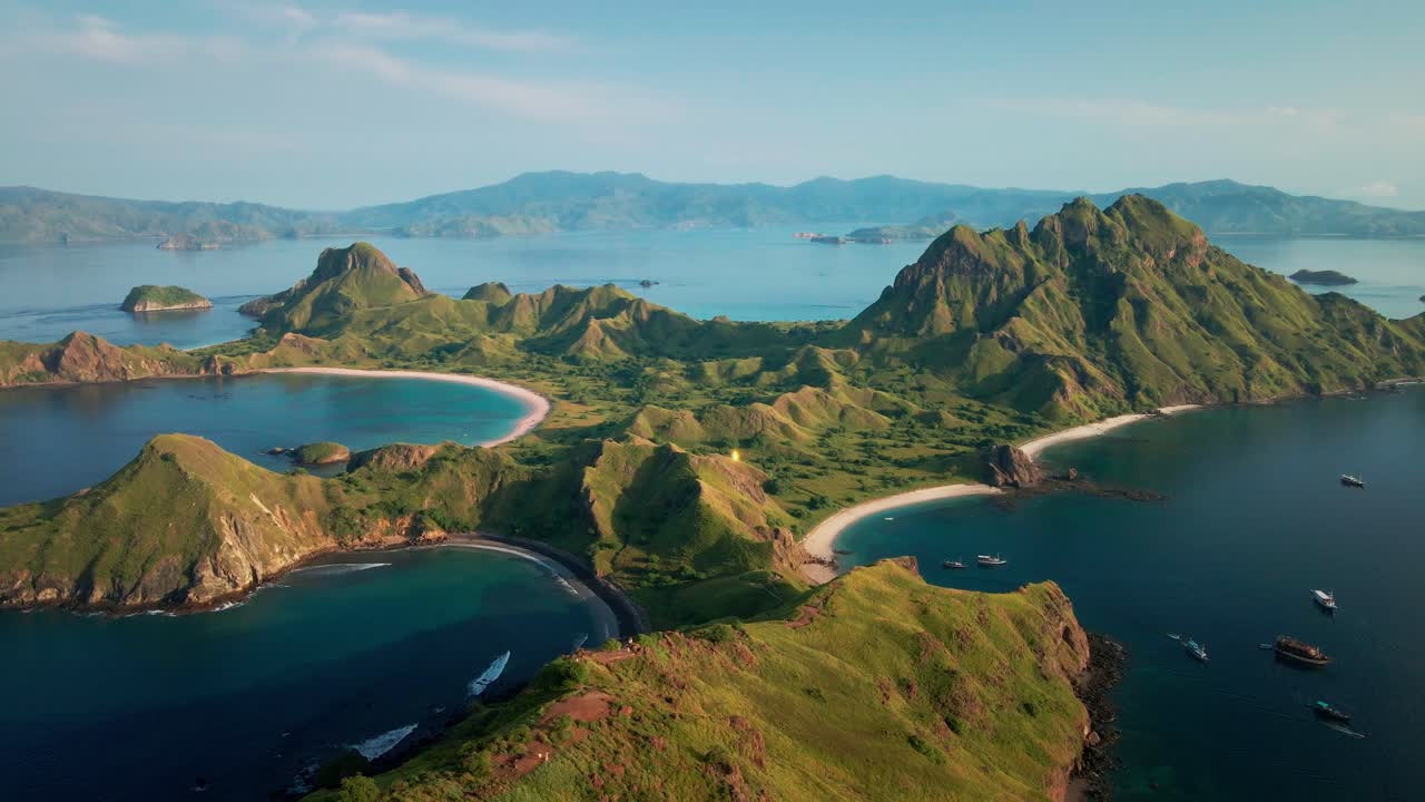 Beautiful wild rugged landscape of Padar Island, Komodo National Park, in the bright morning, showcasing the exotic emerald sea with pristine beaches. A tropical paradise and travel destination.