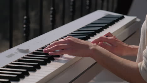 woman playing a digital piano