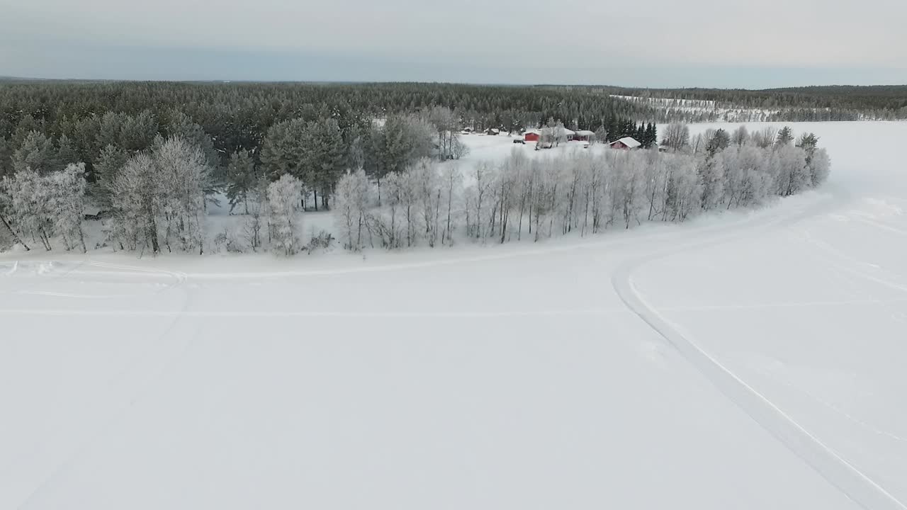 Winter wonderland landscape with frosted trees and cabins