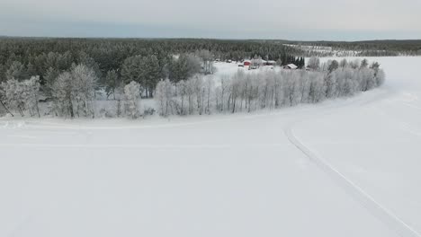 winter wonderland landscape with frosted trees and cabins