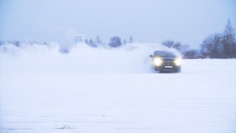 dark blue suv driving on snowy field