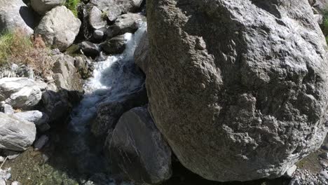 rocky river bed through crystal clear water in slow motion