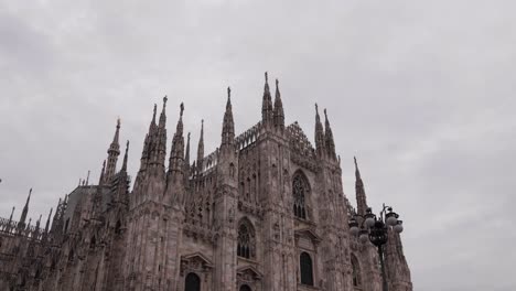 A-panoramic-shot-of-the-grandeur-of-Milan's-Duomo,-a-magnificent-example-of-Italian-baroque-architecture,-adorned-with-statues