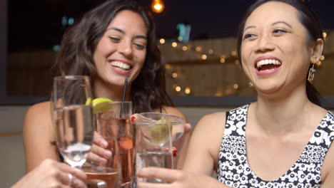 female friends enjoying night out at rooftop bar shot on r3d