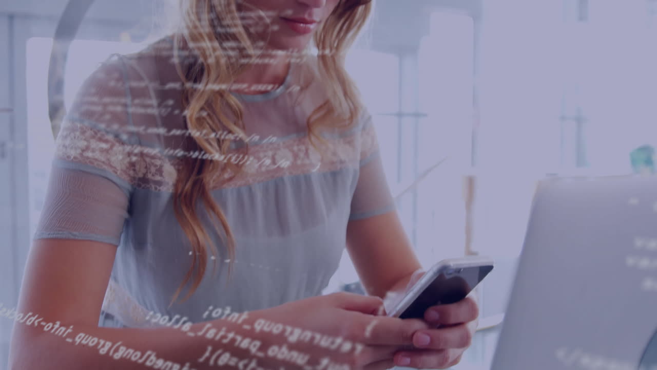 Woman using smartphone and laptop in modern tech workspace, displaying animated code overlay