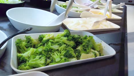 Fresh green broccoli in salad bar station were picked into the dish
