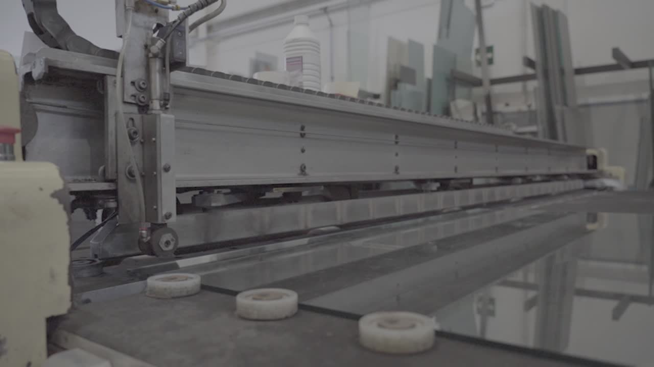 Cutting glass robotic equipment, window glass manufacturing, closeup shot