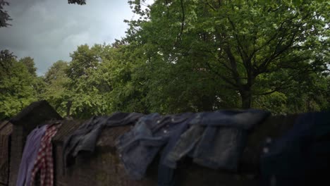 Revealing-a-graveyard-behind-a-brickstone-wall-with-clothes-drying