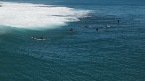 aerial footage of surfers going over waves at jake’s point western australia