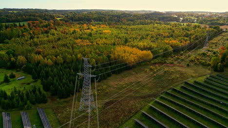 autumn forest and solar panels, energy lines in between, amazing color aerial view, future energy, copy space