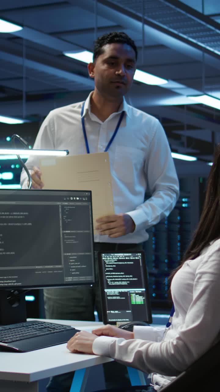 IT Professionals Collaborating on Code in a Server Room