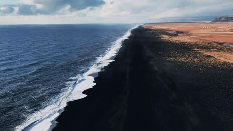 high angled view of the black sand beach in iceland during a sunny and hot day in the summer