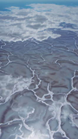 reflective salt flats with cloudscape