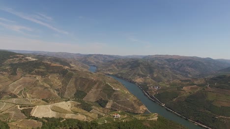 the douro river crossing mountains, portugal