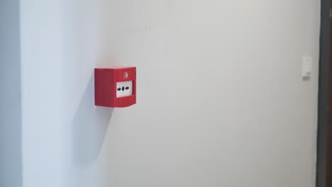 red fire alarm panel on a wall