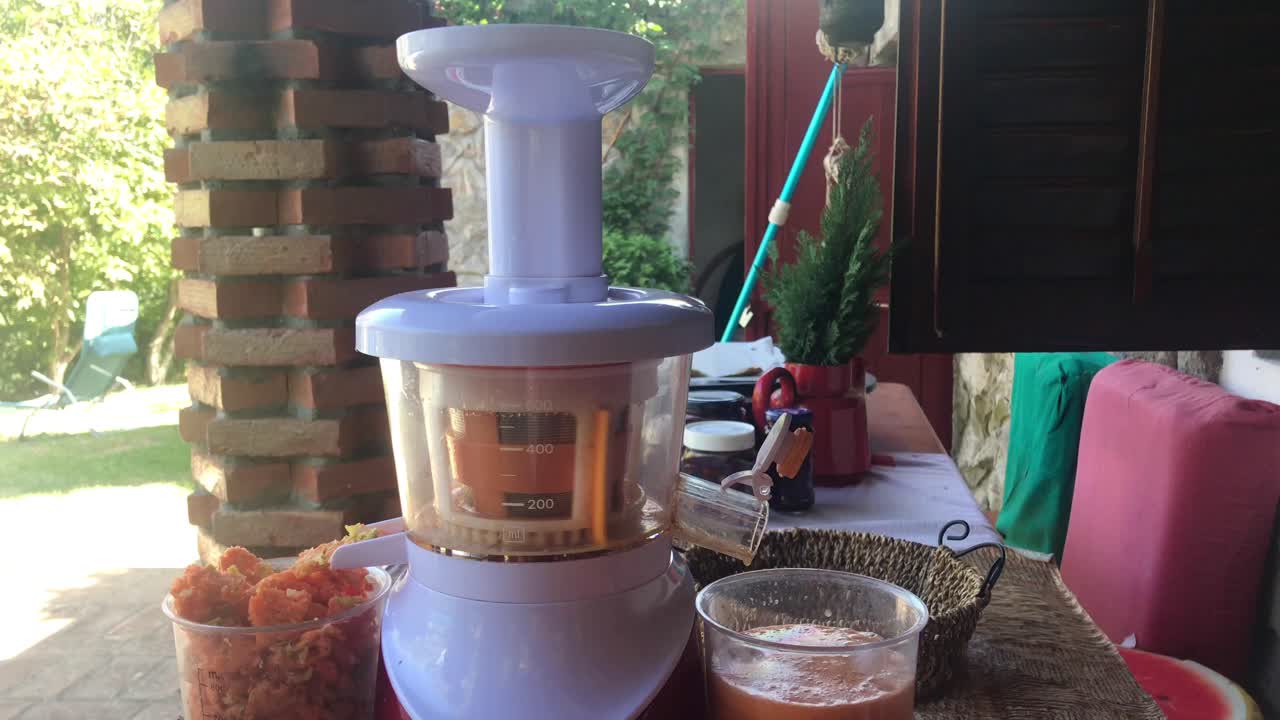 Closeup of juicing wild apples with outdoor rural patio background