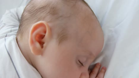 Baby-sleeping-on-a-white-sofa