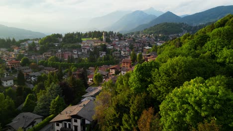 expansive aerial view of selvino nestled in hills, bathed in soft light with ridged mountains in the backdrop. shot at selvino, italy (selvino, italia)