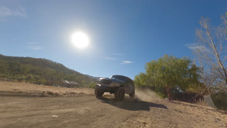 Drone-view-follow-black-pick-up-driving-fast-on-dusty-road