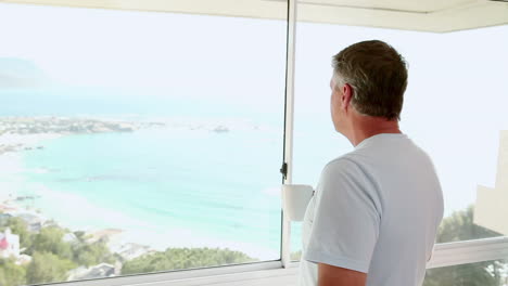 Mature-man-looking-out-at-the-beach