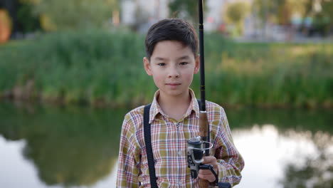 young boy fishing in a park