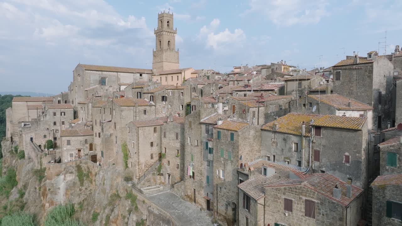 Aerial Drone view of the hilltop Medieval town of Pitigliano, Tuscany in morning light, approaching red tile roofs and old buildings, in 4K