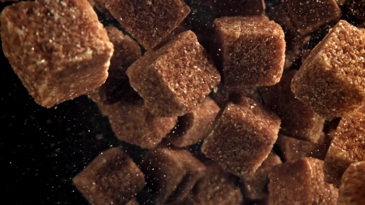 Brown Sugar Cubes Floating in Slow Motion on a Dark Background