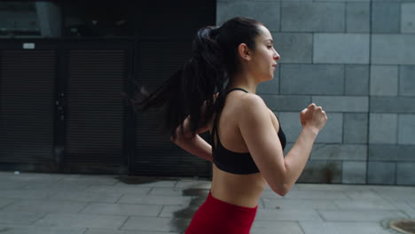 Close-up-attractive-woman-running-outdoor.-Runner-woman-training-run-exercise.