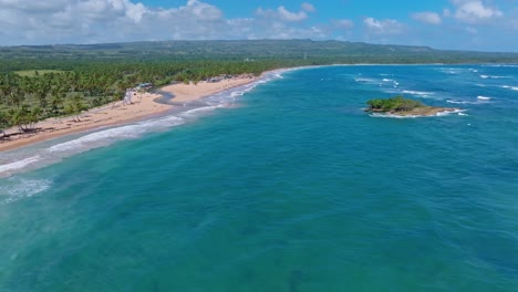 Small-rocky-islet-close-to-coastline-of-idyllic-Playa-Arroyo-Salado,-aerial-view