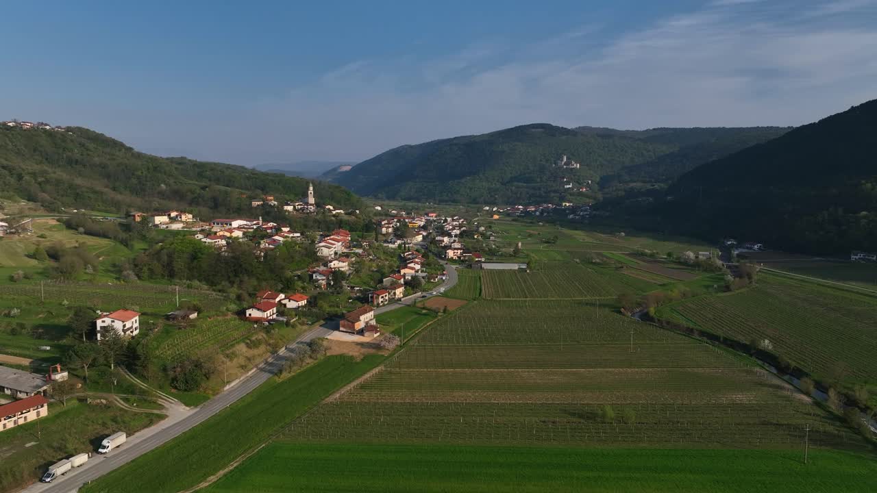 Moving drone shot capturing isolated village at Vipava Valley in Slovenia during daytime