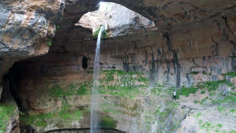 Baatara-Gorge-Waterfall-And-The-Natural-Bridges,-Tannourine,-Lebanon,-tourist-near-the-waterfall---static-shot