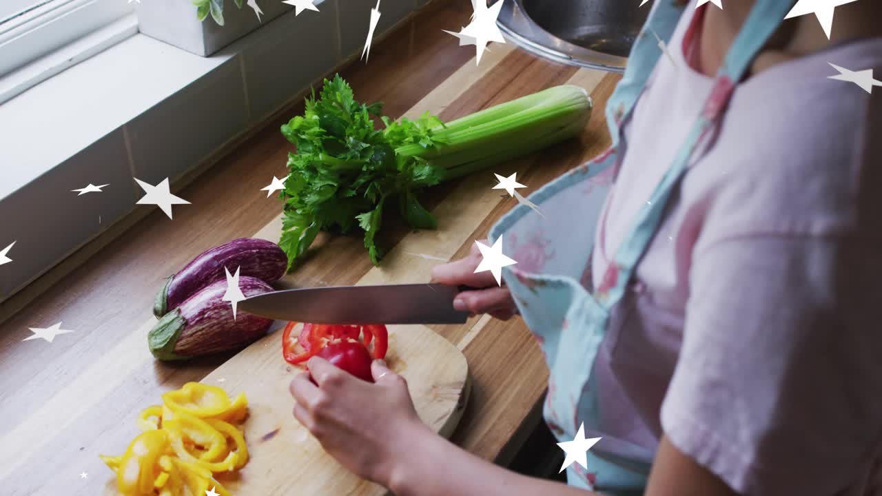 Home cook gripping knife and slicing red pepper into rings for cooking with digital star overlay
