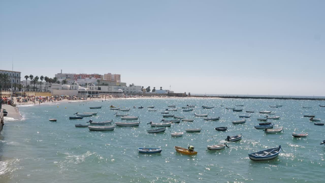 Boats docked close to the beach in Cadiz, Spain