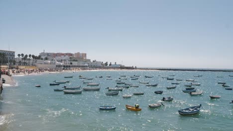 boats docked close to the beach in cadiz, spain