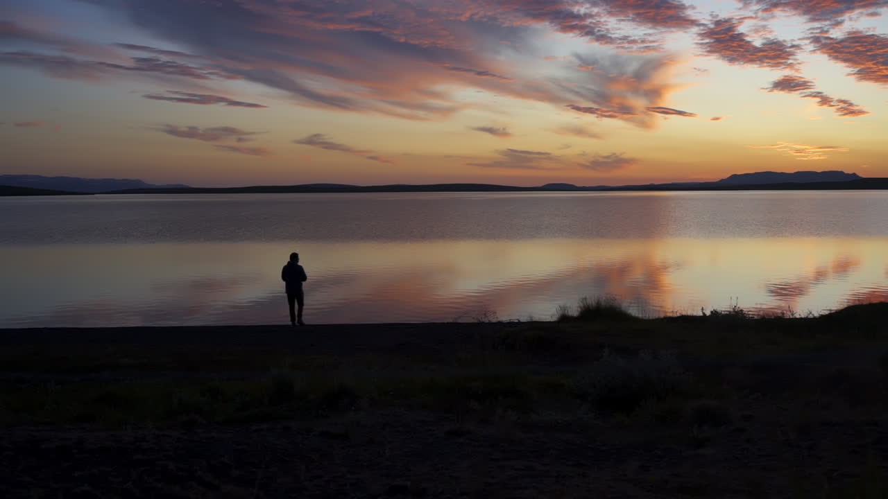 Silhouette Of Man Standing In Icelandic Landscape - Wide Shot