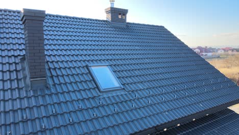 aerial view of house roof top covered with ceramic shingles. tiled covering of building under construction