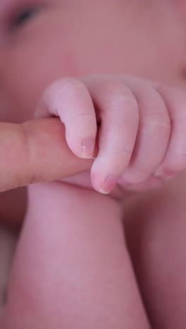 Adorable Baby Gently Grasping a Finger Showing Pure Warmth and Deep Emotional Connection Adorable Baby Gently Grasping a Finger Showing Pure Warmth and Deep Emotional Connection
