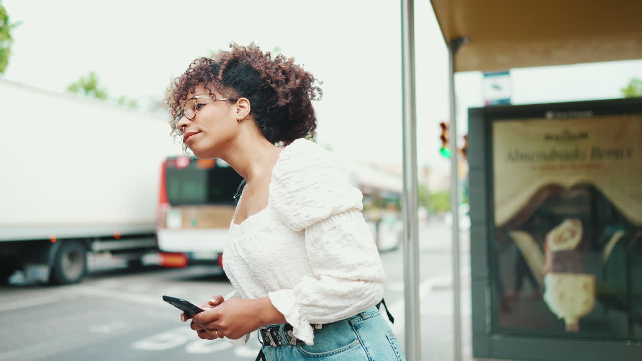 Woman waiting at a bus stop