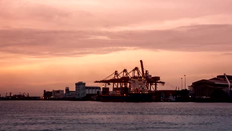 4k timelapse, cargo ship loading cargo into the docks