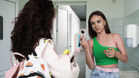 girls talking in the bathroom