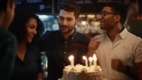 joyful celebration with friends: capturing moments of laughter and togetherness in a vibrant atmosphere where everyone enjoys the festivities with cake and candles