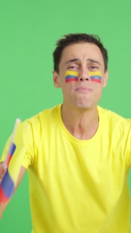Man cheering for Colombia during a match that is lost