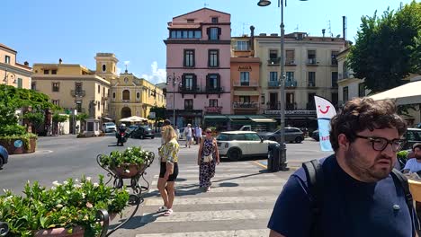 people and traffic in a bustling square