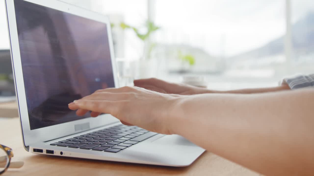 Businesswoman working over laptop at her desk