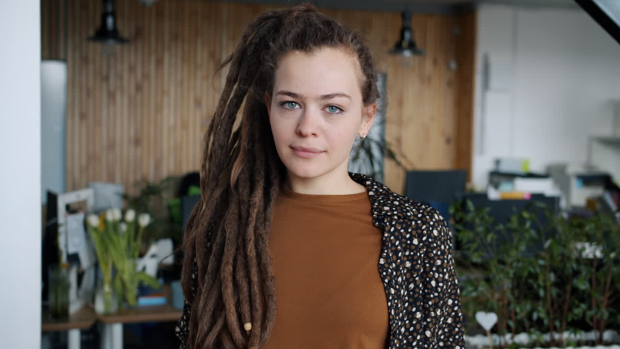 Young woman with dreadlocks in a modern office