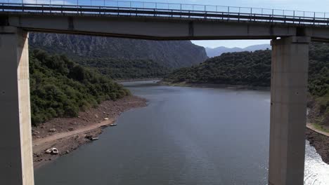 Establishing-shot-of-vehicles-passing-on-bridge-over