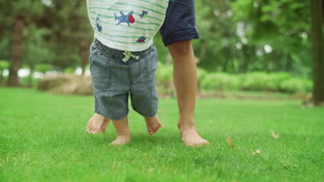 elder brother teaching toddler to walk