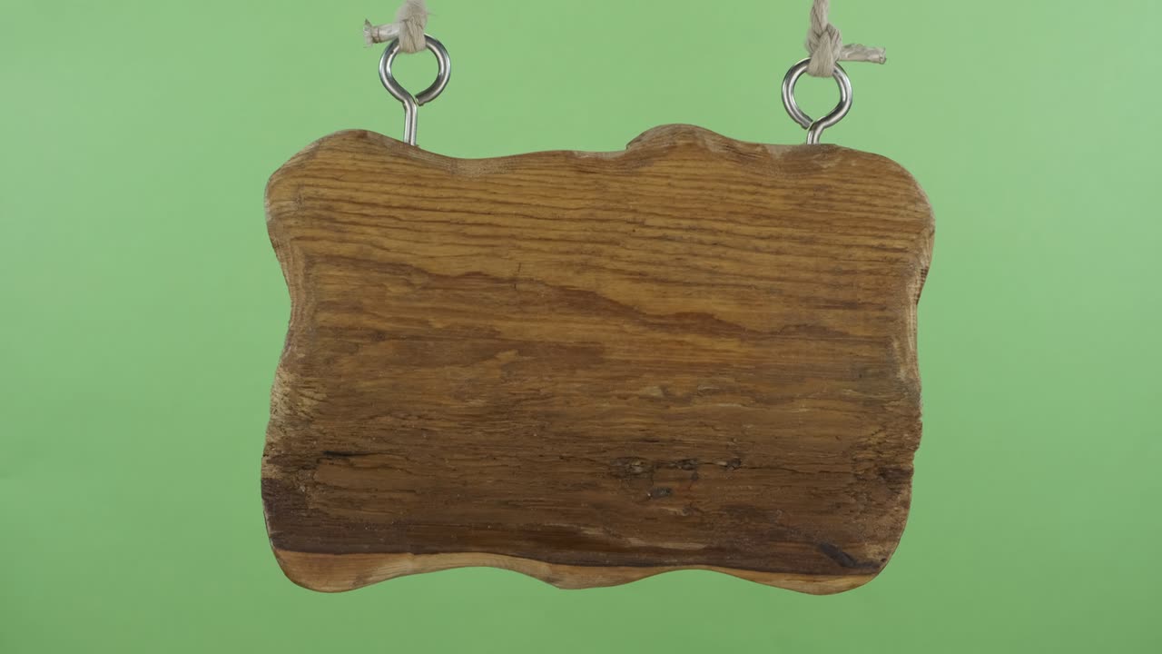 Panorama of a wooden sign hanging on the ropes. Isolated on a green screen