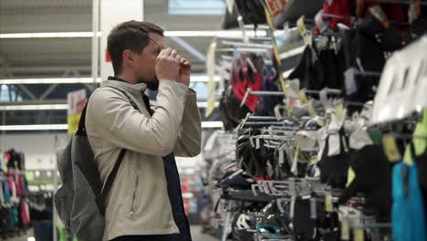 man shopping for sports equipment in a store