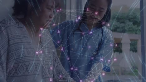 Animation-of-network-of-connections-over-asian-female-doctor-treating-patient